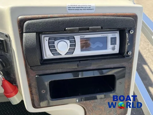 Slide: The Image of 2000 Weeres Sundeck 280 TT pontoon boat with 2021 Honda 100HP engine, parked outdoors. - 26