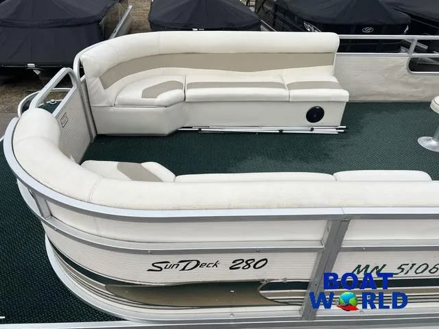 Slide: The Image of Pontoon boat Weeres Sundeck 280 with white seating, 2000 model, featuring 2021 Honda 100HP engine. - 3