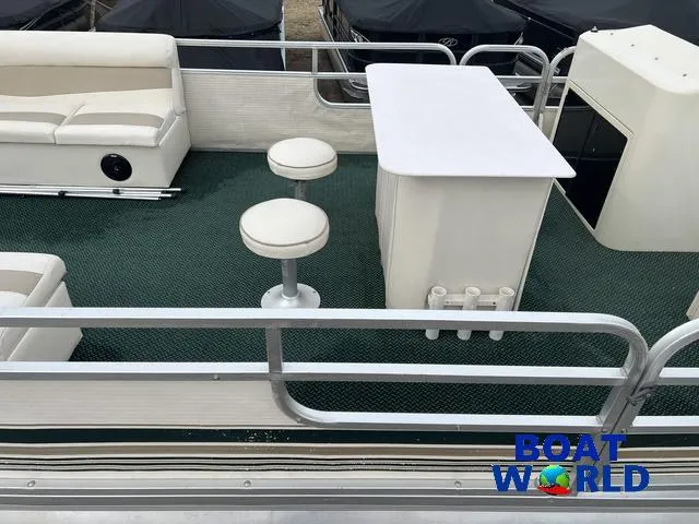 Slide: The Image of Pontoon boat interior with seating, table, and stools, Weeres Sundeck 280, 2000 model. - 6