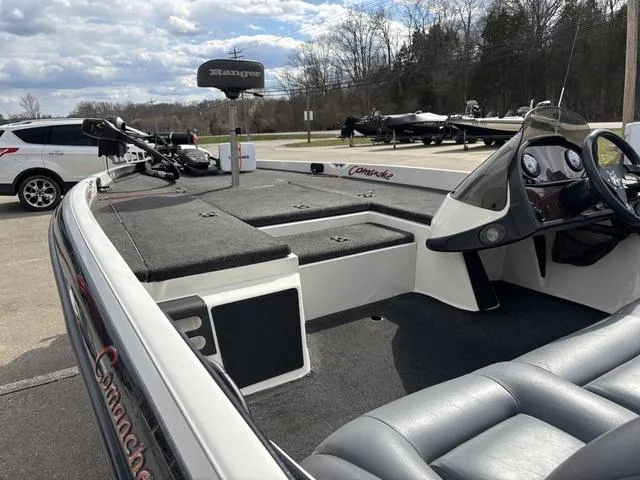 Slide: The Image of 2001 Ranger 518VX boat interior with steering wheel and seating, parked outdoors. - 10