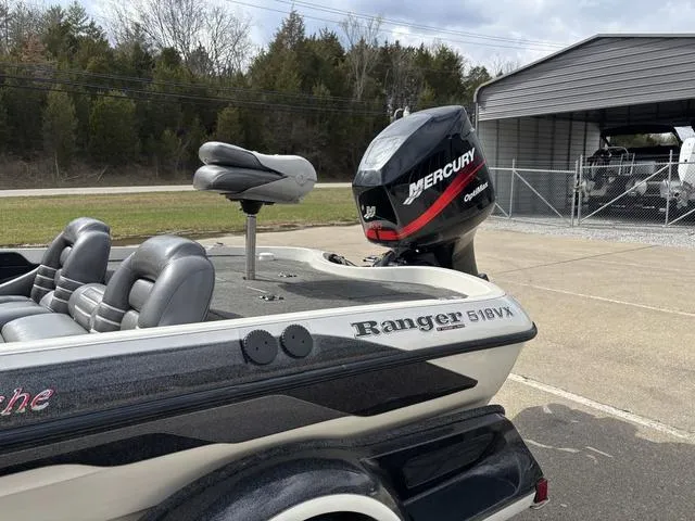 Slide: The Image of 2001 Ranger 518VX boat with Mercury outboard motor, parked near a garage. - 11