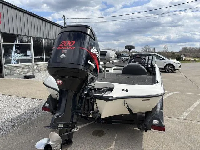 Slide: The Image of 2001 Ranger 518VX boat with Mercury 200 engine, parked outdoors. - 2