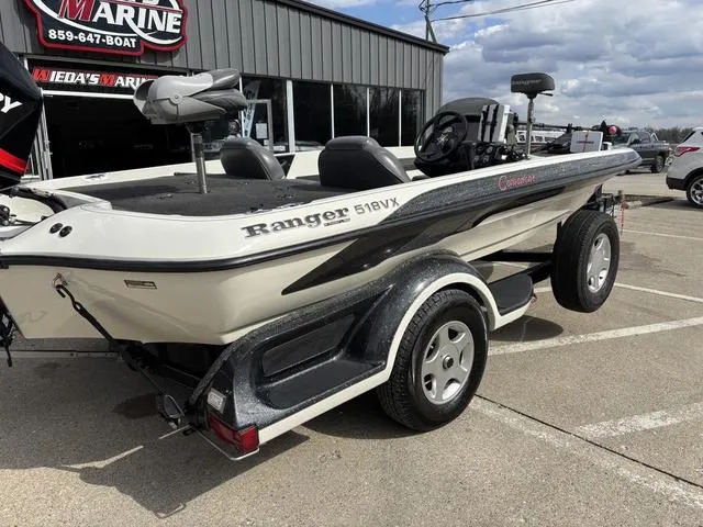 Slide: The Image of 2001 Ranger 518VX boat parked outside a marine dealership on a sunny day. - 3