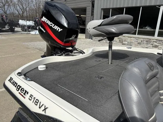 Slide: The Image of 2001 Ranger 518VX boat with Mercury engine, gray seating, and outdoor setting. - 5