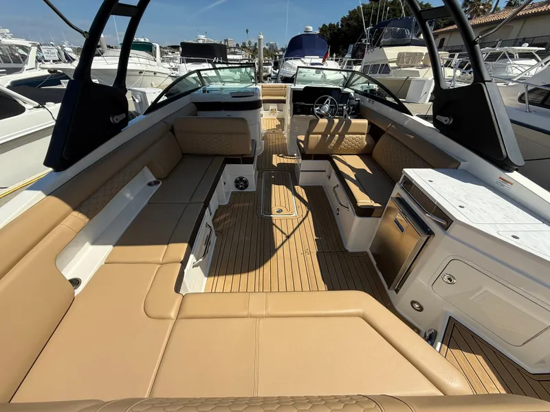 Slide: The Image of 2022 Sea Ray 290 SDX OB boat interior with tan seating and modern amenities. - 10