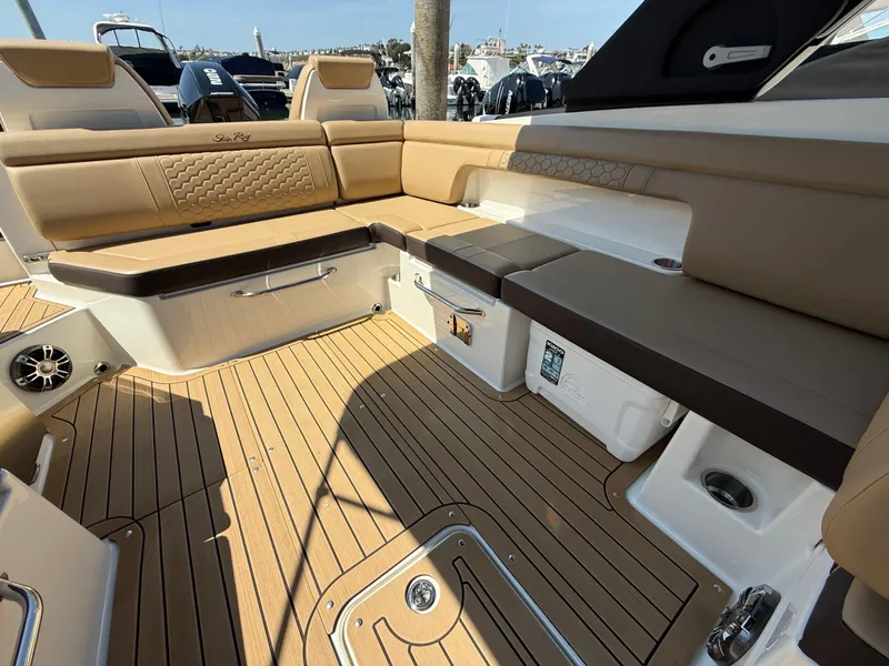 Slide: The Image of Luxurious 2022 Sea Ray 290 SDX OB boat interior with tan seating and teak flooring. - 13