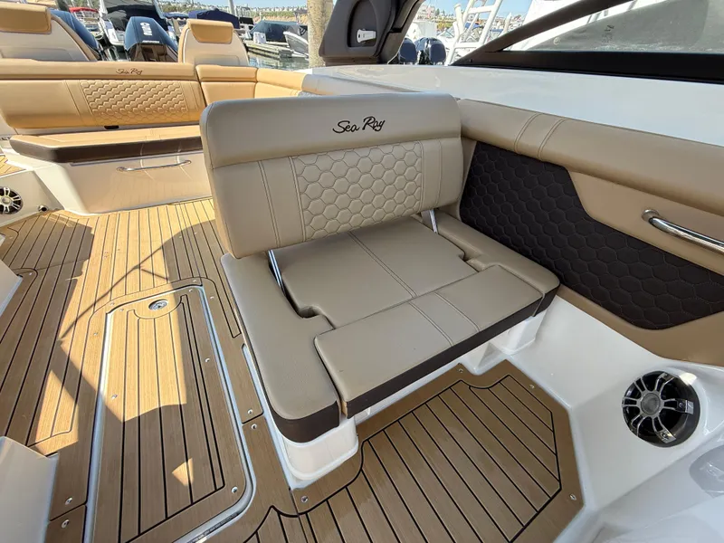 Slide: The Image of Luxurious interior of 2022 Sea Ray 290 SDX OB boat with tan seating and wood flooring. - 15