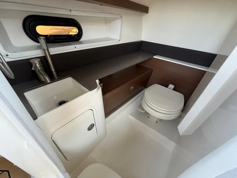 Slide: The Image of 2022 Sea Ray 290 SDX OB boat bathroom with sink, toilet, and storage. - 25