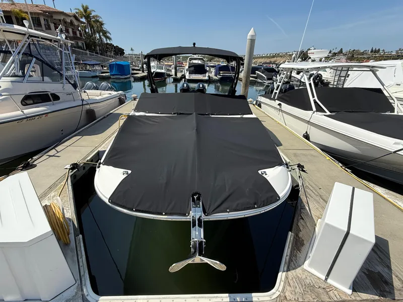Slide: The Image of 2022 Sea Ray 290 SDX OB boat docked with black cover in marina. - 28