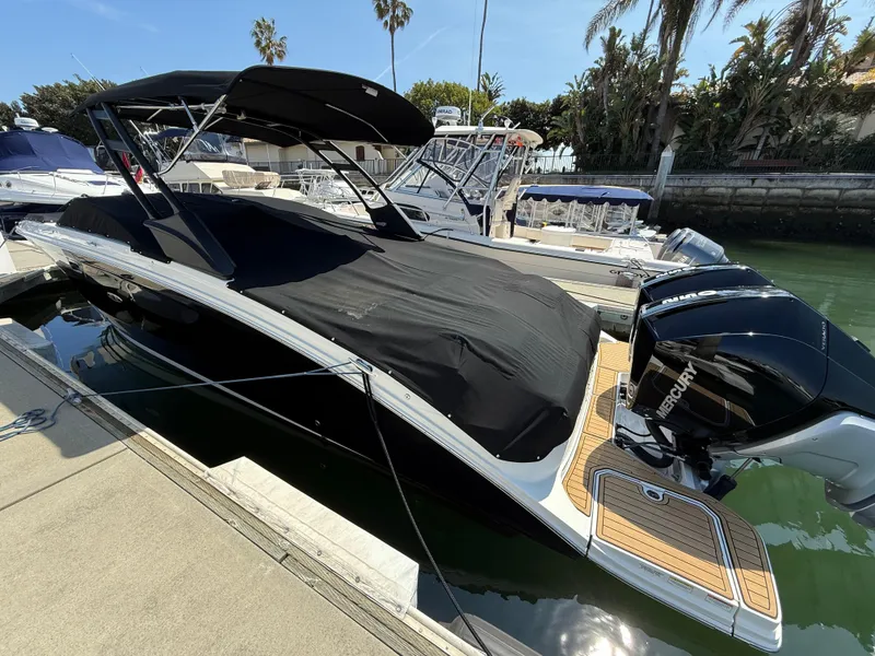 Slide: The Image of 2022 Sea Ray 290 SDX OB boat docked, covered, with twin Mercury outboard engines. - 29