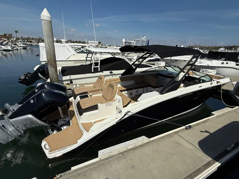 Slide: The Image of 2022 Sea Ray 290 SDX OB boat docked at marina, featuring sleek design and spacious seating. - 3