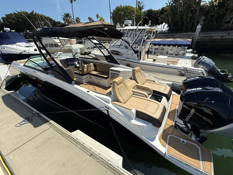 Slide: The Image of 2022 Sea Ray 290 SDX OB boat docked, featuring sleek design and comfortable seating. - 4