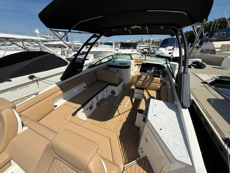 Slide: The Image of 2022 Sea Ray 290 SDX OB boat with spacious seating and sleek design at marina. - 8