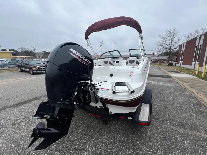 Slide: The Image of 2022 Tahoe 185 S boat with Mercury engine on a trailer, parked on a street. - 12