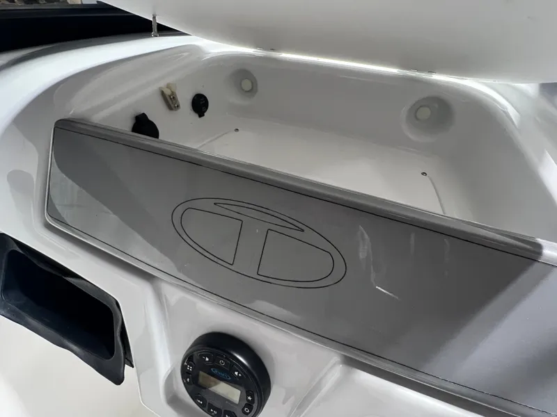 Slide: The Image of 2022 Tahoe 185 S boat interior storage compartment with logo and control panel. - 19