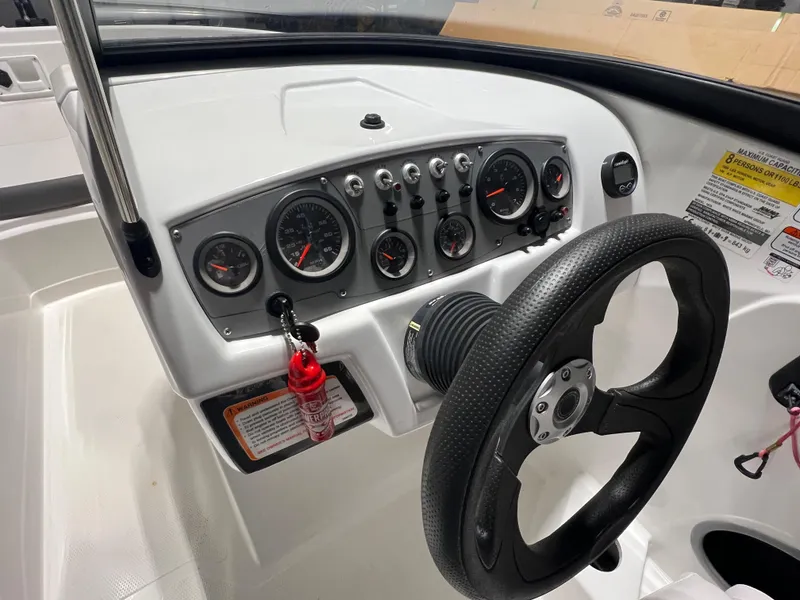 Slide: The Image of Dashboard of 2022 Tahoe 185 S boat with steering wheel and gauges. - 21