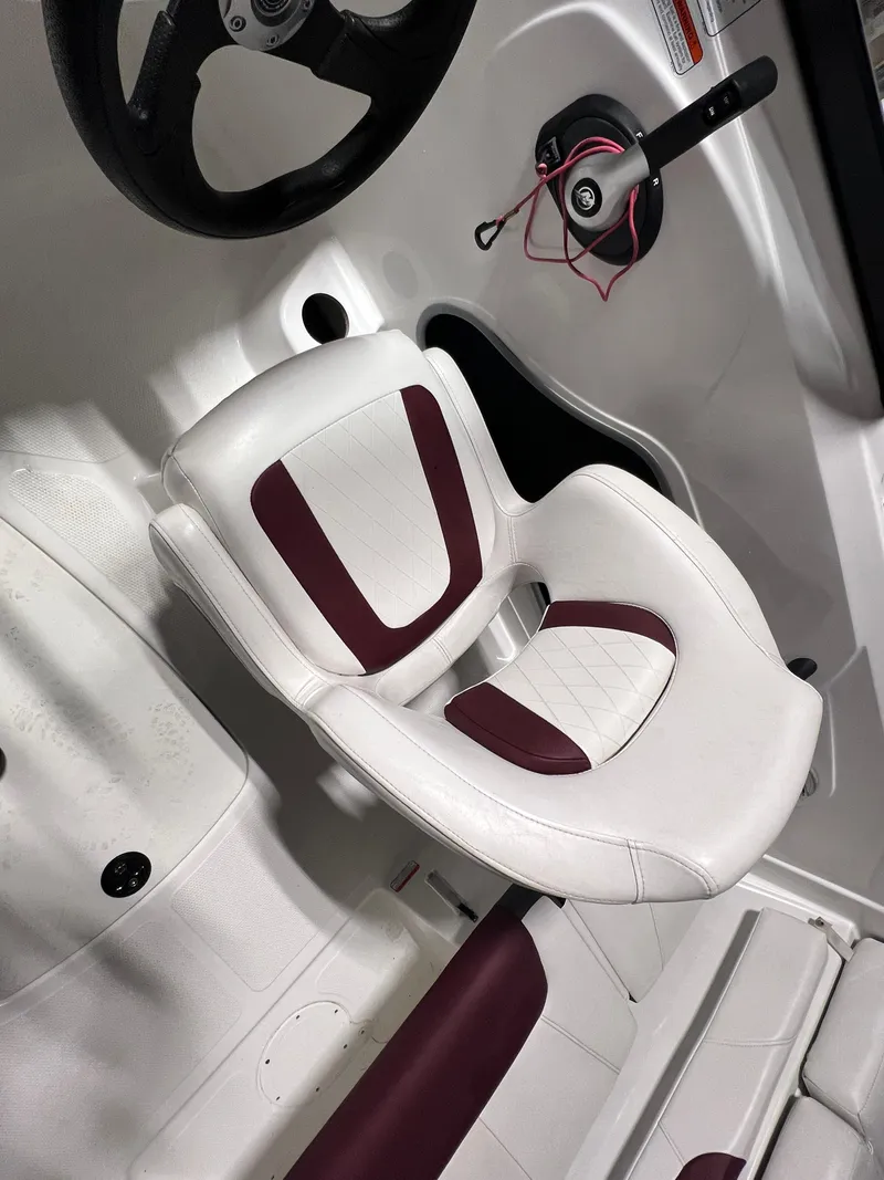 Slide: The Image of 2022 Tahoe 185 S boat interior with white and maroon seating. - 23