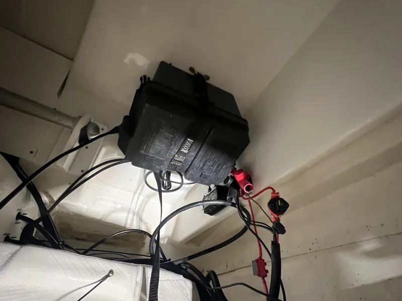 Slide: The Image of Battery compartment of 2022 Tahoe 185 S boat with wiring connections. - 27