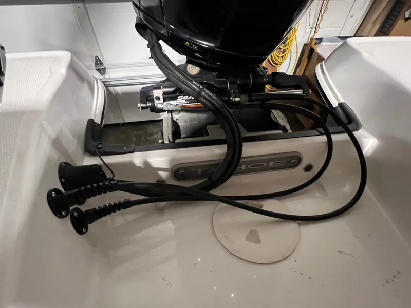 Slide: The Image of 2022 Tahoe 185 S boat engine compartment with cables and motor components. - 28