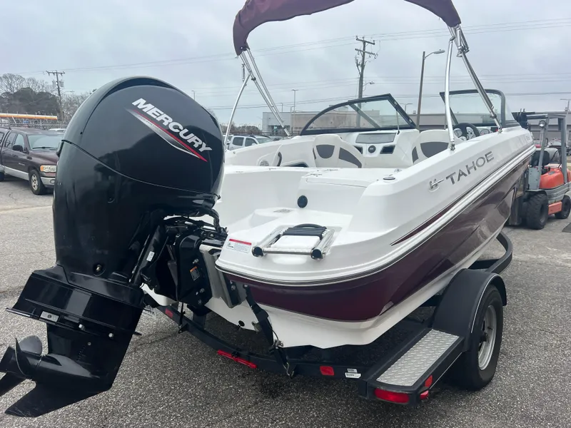 Slide: The Image of 2022 Tahoe 185 S boat on trailer, red and white design, parked outdoors. - 5