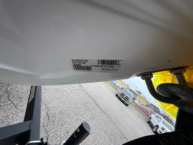 Slide: The Image of 2022 Tahoe 185 S boat hull with visible identification label in parking lot. - 9