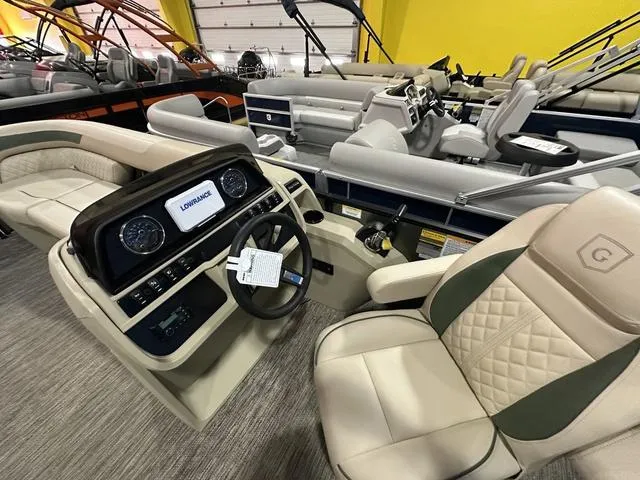 Slide: The Image of 2025 Godfrey Sweetwater 2286 SFL Sport Tube pontoon boat interior with steering console and seating. - 16