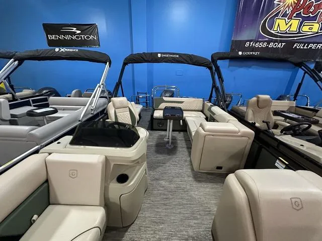 Slide: The Image of 2025 Godfrey Sweetwater 2286 SFL Sport Tube pontoon boat interior with seating and table. - 19