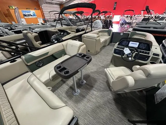 Slide: The Image of Luxurious 2025 Godfrey Sweetwater 2286 SFL pontoon boat interior with plush seating and modern dashboard. - 7