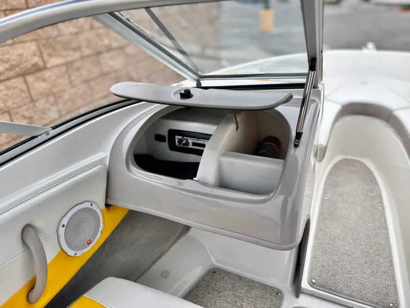 Slide: The Image of 2005 Maxum 1800 SR3 boat interior with open glove compartment and speaker. - 19