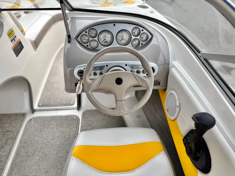 Slide: The Image of 2005 Maxum 1800 SR3 boat dashboard with steering wheel and gauges. - 23