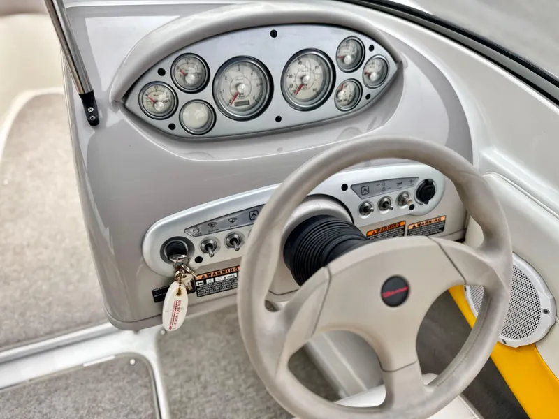 Slide: The Image of 2005 Maxum 1800 SR3 boat dashboard with steering wheel and gauges. - 24