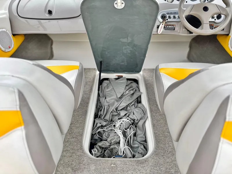 Slide: The Image of 2005 Maxum 1800 SR3 boat interior with open storage compartment between seats. - 25