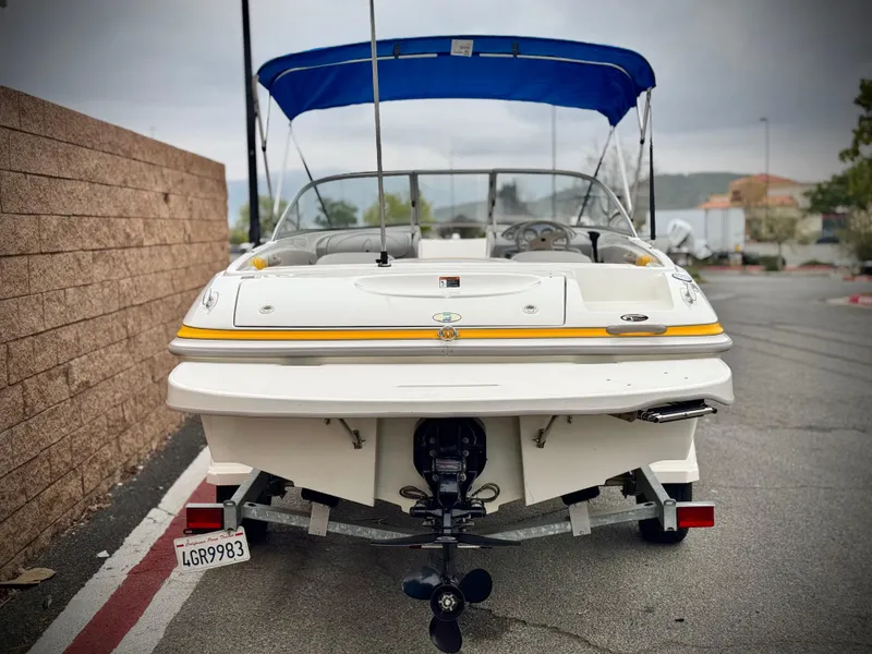 Slide: The Image of 2005 Maxum 1800 SR3 boat with blue canopy, parked on a street. - 4