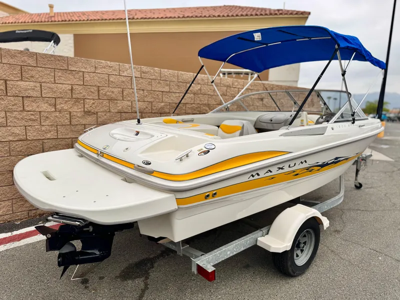 Slide: The Image of 2005 Maxum 1800 SR3 boat with blue canopy on a trailer. - 5