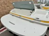 Slide: The Image of 2005 Maxum 1800 SR3 boat with open storage compartment, white and yellow design. - 7