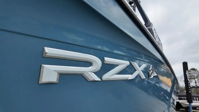 Slide: The Image of 2021 Tigé RZX Class 22 RZX boat, close-up of logo on blue hull. - 11