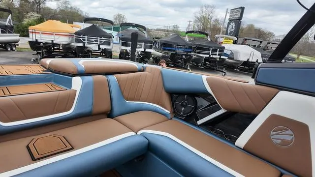 Slide: The Image of 2021 Tigé RZX Class 22 RZX boat interior with brown and blue seating. - 16
