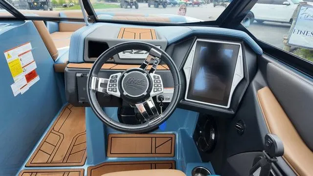 Slide: The Image of 2021 Tigé RZX Class 22 RZX boat dashboard with touchscreen and steering wheel. - 18