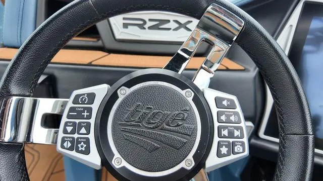 Slide: The Image of Steering wheel of 2021 Tigé RZX Class 22 RZX boat with control buttons. - 19