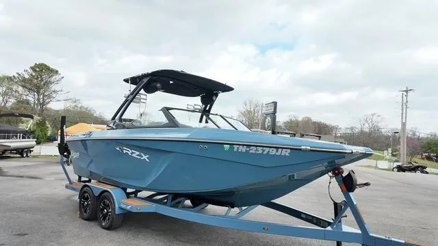 Slide: The Image of 2021 Tigé RZX Class 22 RZX boat on trailer, parked outdoors. - 4