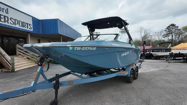 Slide: The Image of 2021 Tigé RZX Class 22 RZX boat on trailer, parked outside dealership. - 5