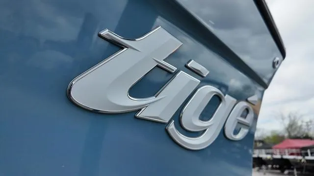 Slide: The Image of 2021 Tigé RZX Class 22 RZX logo on blue boat exterior. - 9