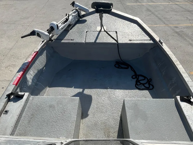 Slide: The Image of 1991 Scully's 18ft Aluminum Walk Thru boat, interior view, featuring open deck and equipment. - 11