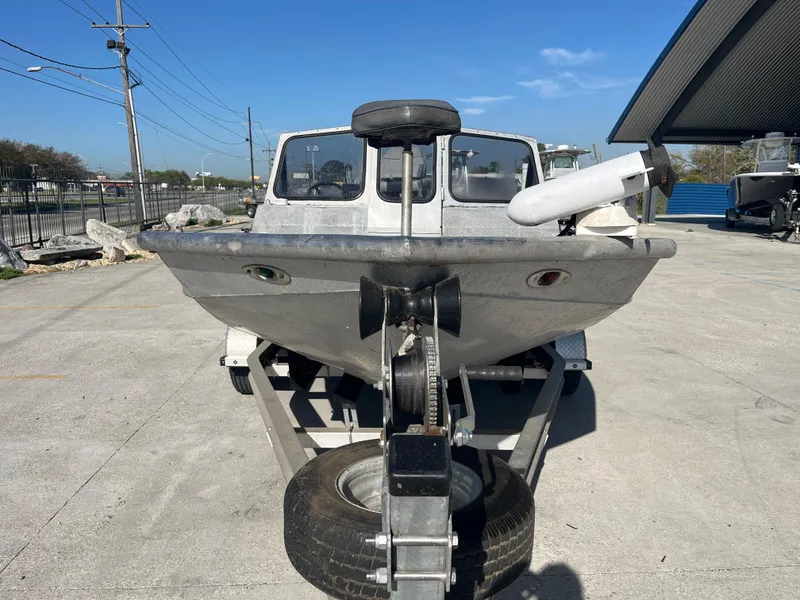 Slide: The Image of 1991 Scully's 18ft Aluminum Walk Thru boat on trailer, parked outdoors. - 3