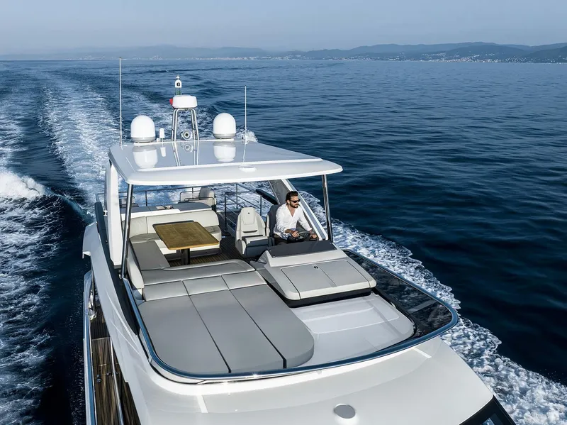 Slide: The Image of 2026 Absolute 52 FLY yacht cruising on open sea with clear skies. - 6