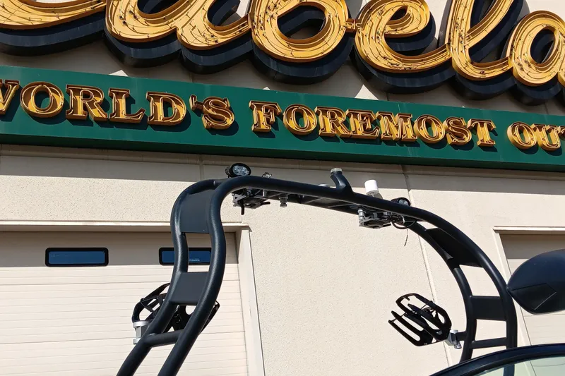 Slide: The Image of 2014 Correct Craft Super Air Nautique 230 near Cabela's store sign. - 12