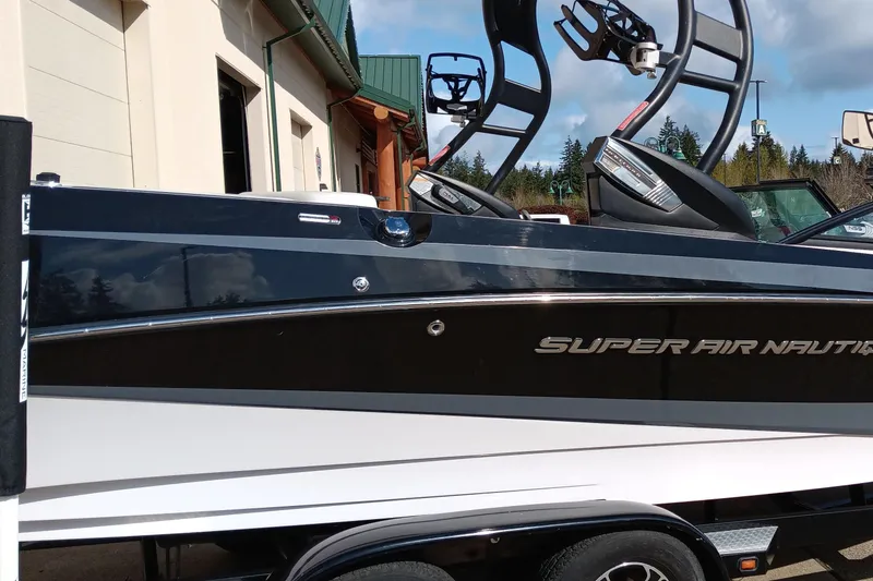 Slide: The Image of 2014 Correct Craft Super Air Nautique 230 boat on trailer, side view. - 3