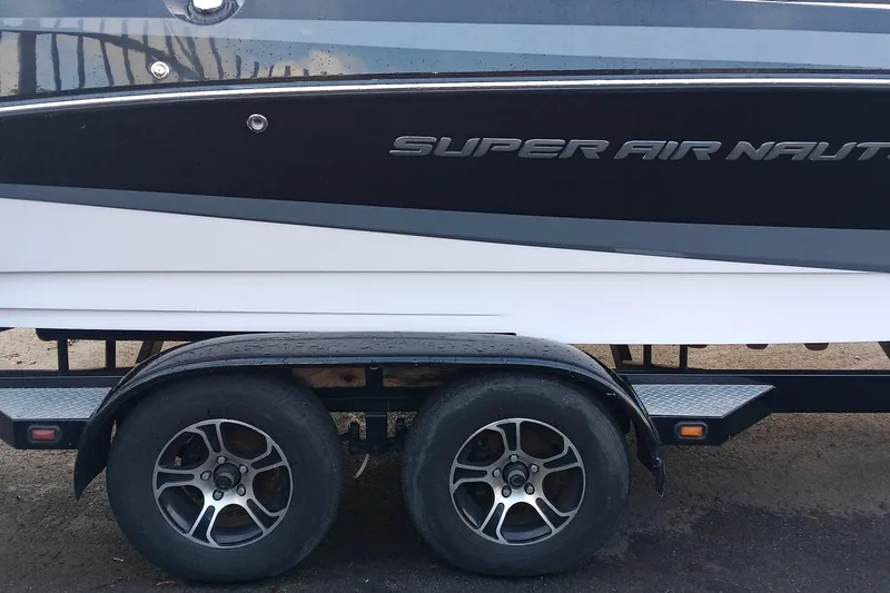 Slide: The Image of 2014 Correct Craft Super Air Nautique 230 on a dual-axle trailer. - 4