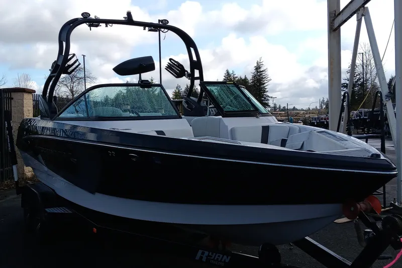 Slide: The Image of 2014 Correct Craft Super Air Nautique 230 boat on trailer, parked outdoors. - 5
