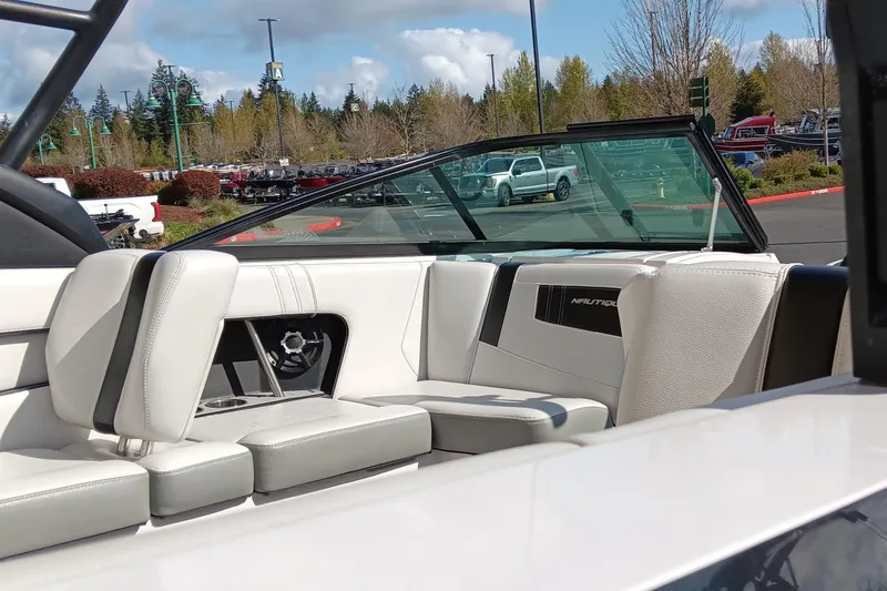 Slide: The Image of 2014 Correct Craft Super Air Nautique 230 interior with white leather seating and sleek design. - 6